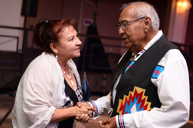 Angie Main shaking hands with an Oweesta event participant