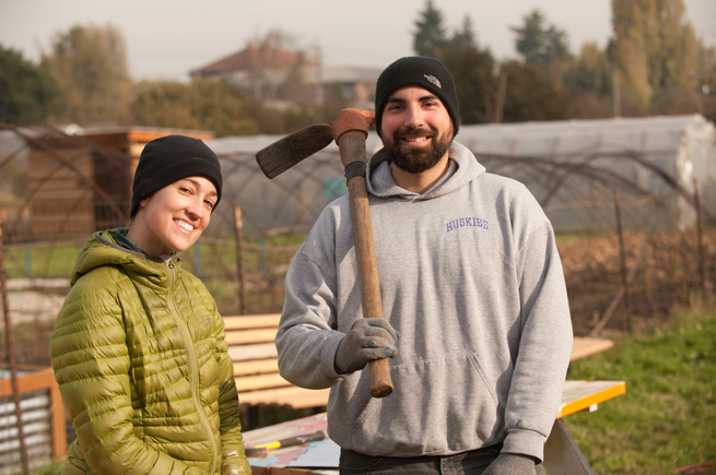 A man and a woman working at a Solid Ground community garden near Seattle