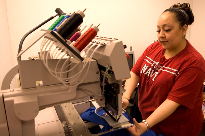 Woman working on an embroidery machine