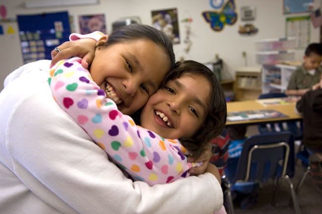 Two Native youth embracing