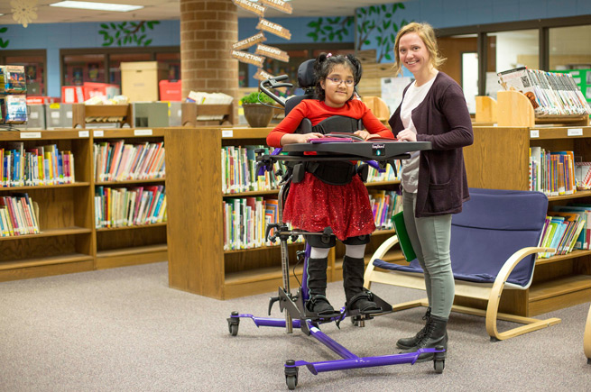 Librarian and a young girl in a library