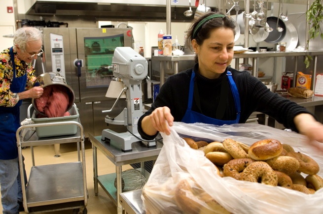 A woman and a man working in an industrial kitchen at a NAYA facility