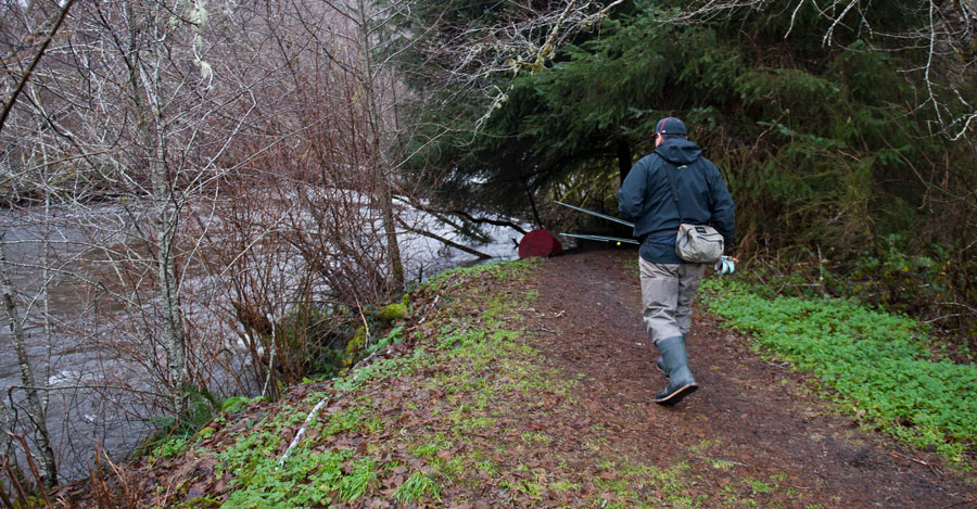 Native American man walking to a river with his fishing pole