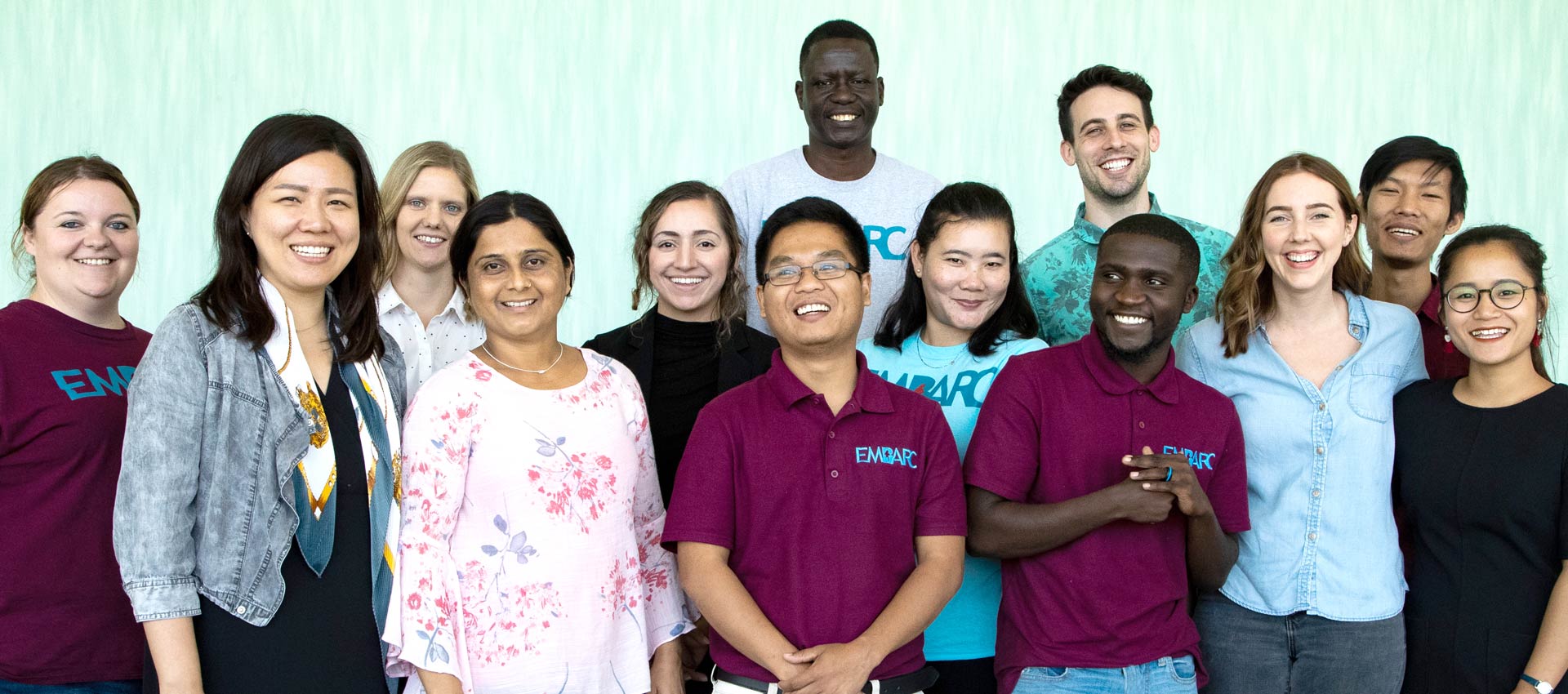 Diverse group of people posed for photo, smiling